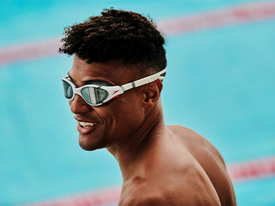 Woman swimming in a gym pool in Speedo swimwear