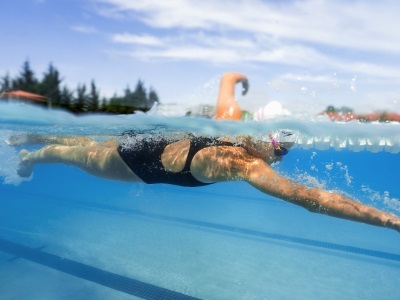Woman swimming in a pool in Speedo swimwear