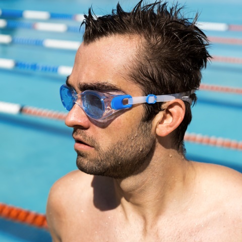 Kid swimming under water with her Speedo swimsuit and swimming goggle